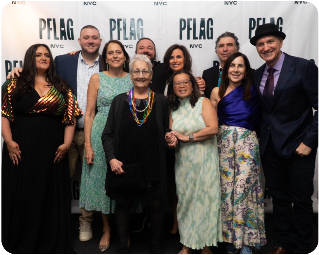 A photo of nine of the PFLAG NYC board members alongside our Executive Director. Everyone is dressed up for our annual gala.