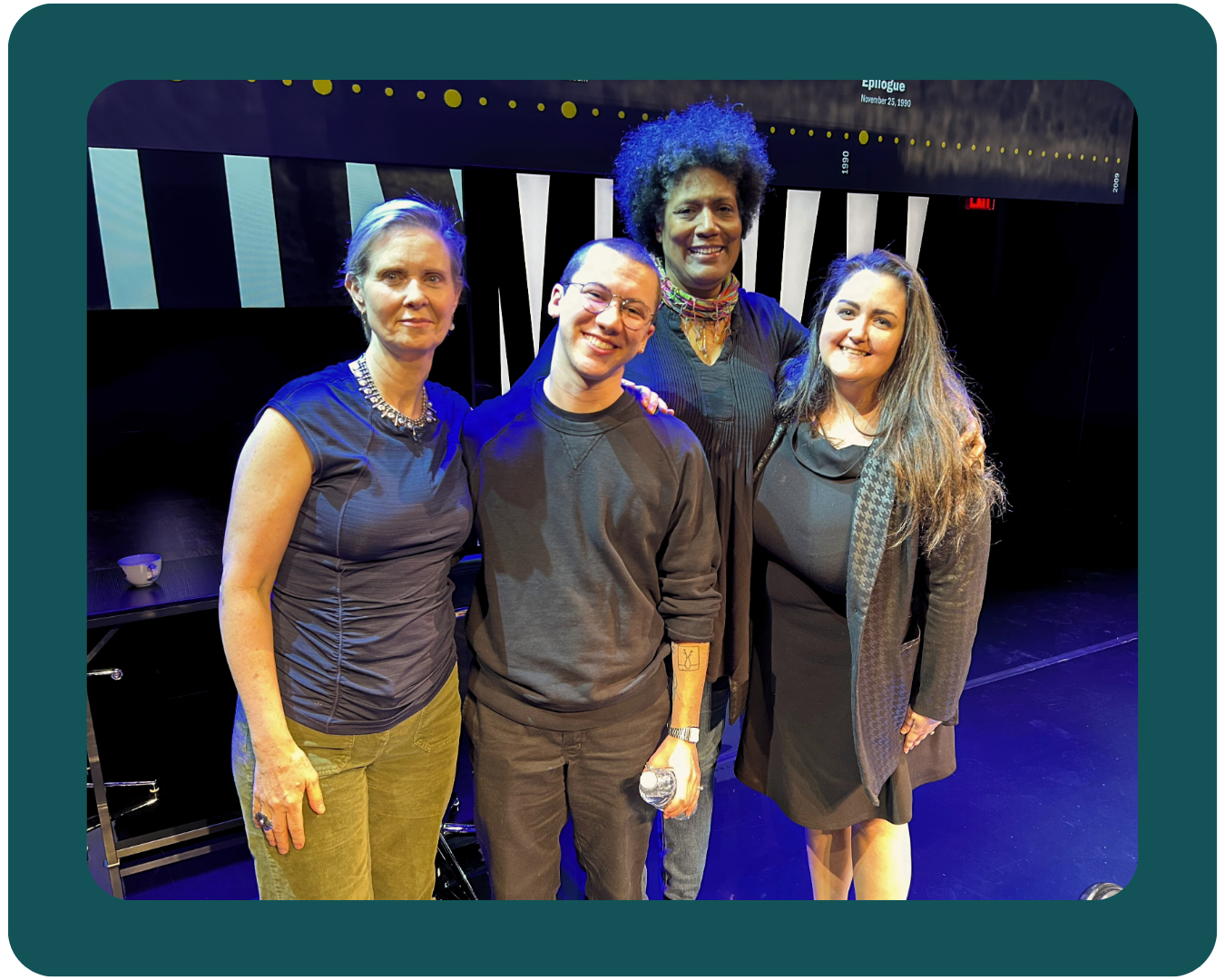 A photo of actresses Cynthia Nixon and Nancy Giles standing and smiling alongside PFLAG staff members Melissa and Clark after a panel event for the Off-Broadway play, The Seven Year Disappear.