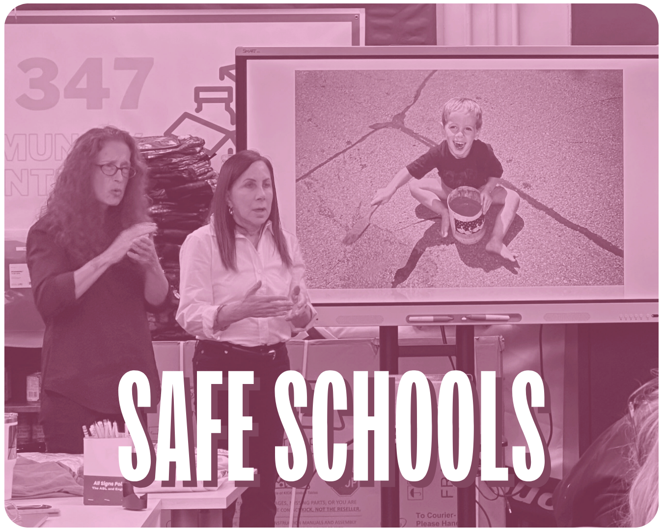 A purple-filtered image of two people giving a presentation in front of a classroom of kids with the words "Safe Schools" over the image.